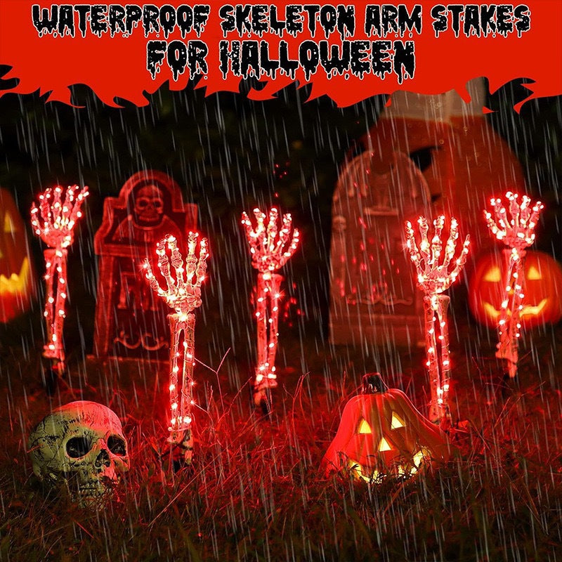Solar-powered glowing skull arm garden stake light