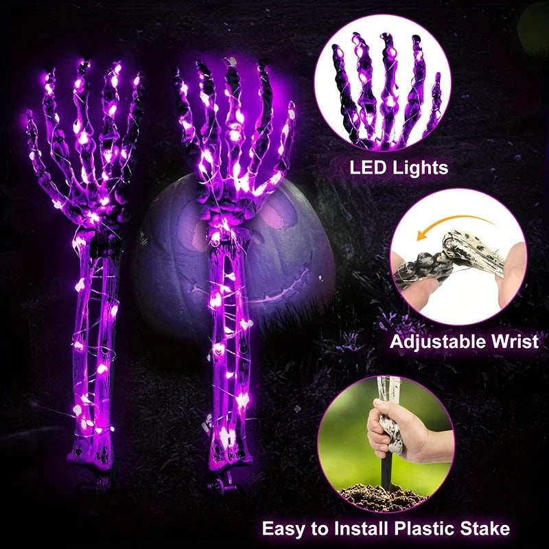 Solar-powered glowing skull arm garden stake light