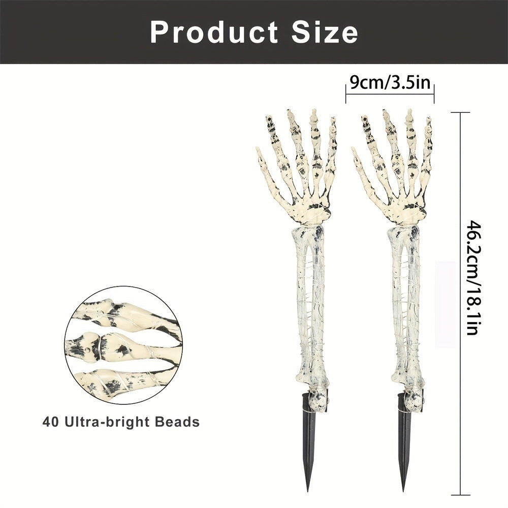 Solar-powered glowing skull arm garden stake light